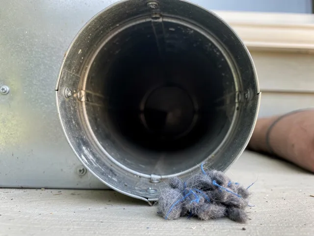 Grove City Dryer Vent Cleaning technician using specialized equipment to clear severe dryer vent blockage in Grove City